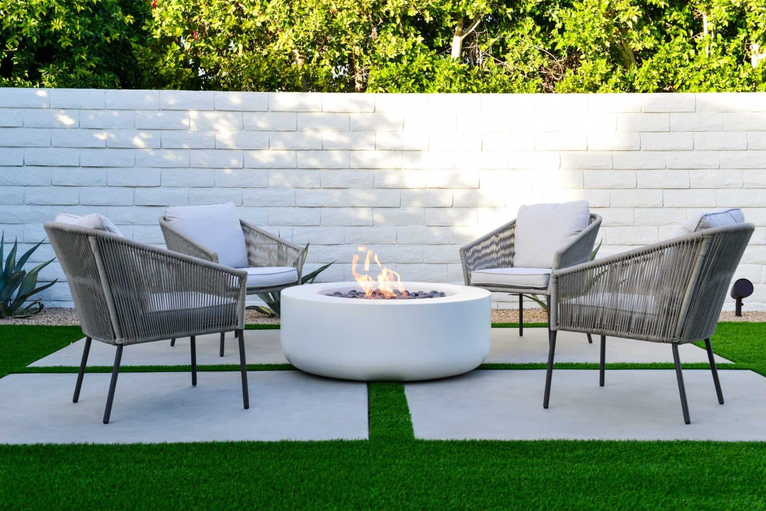 Backyard landscape transformation in Rancho Mirage including hardscape, fire feature, breeze block, masonry, low voltage lighting, artificial turf, irrigation and desert plants.