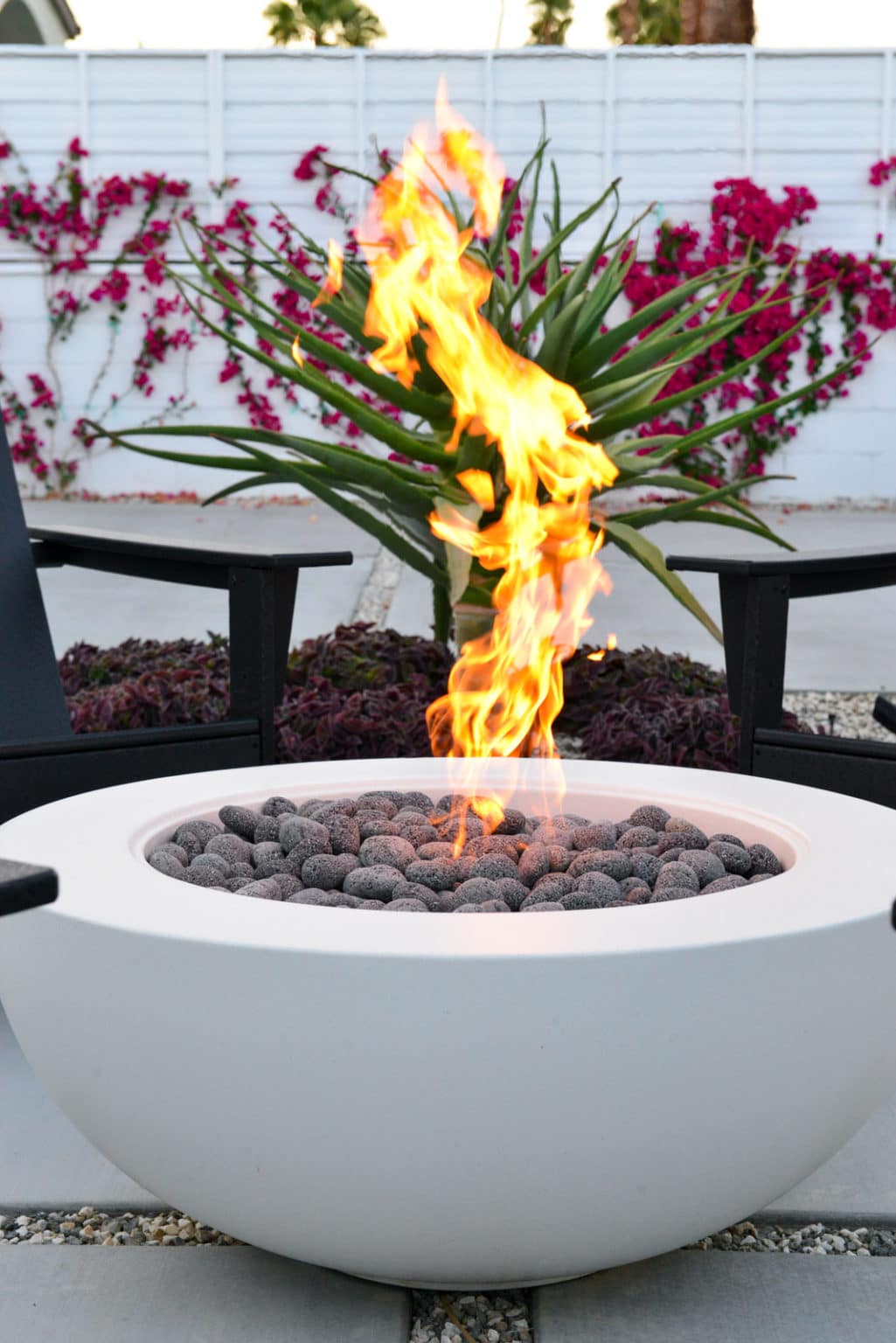 Backyard landscape transformation in Rancho Mirage including hardscape, fire feature, breeze block, masonry, low voltage lighting, artificial turf, irrigation and desert plants.