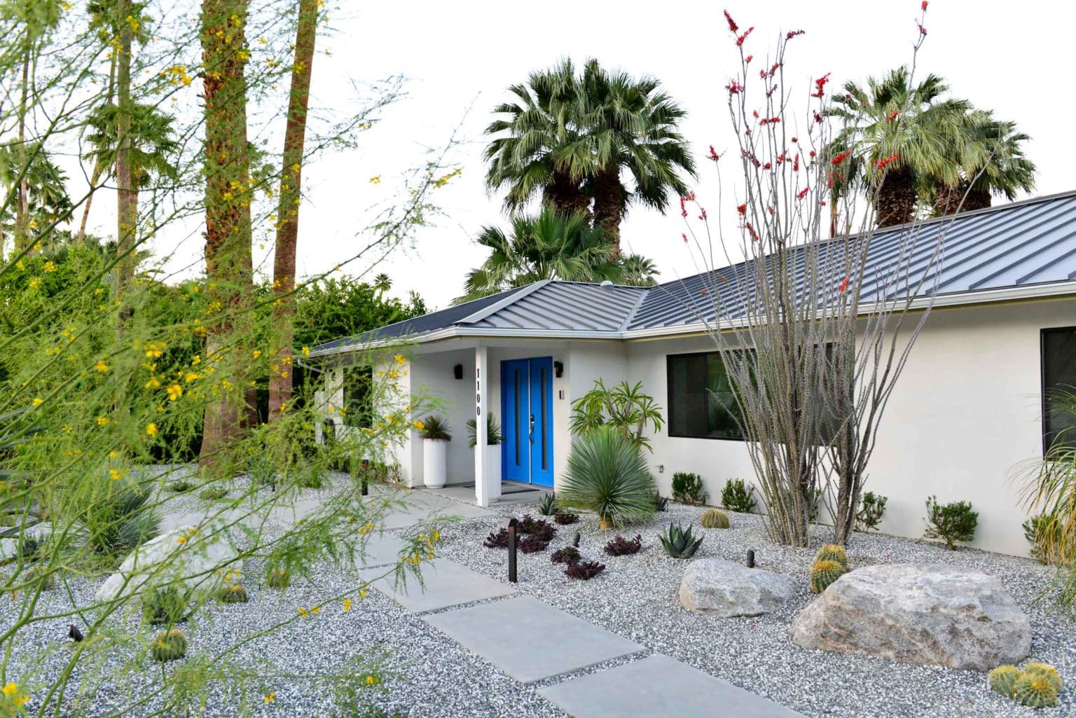 Complete landscape transformation in Palm Springs. Installation includes acid washed hardscape layout, outdoor living area with pizza oven, BBQ, Fireplace, Outdoor shower with breeze block, low voltage lighting, boulders, irrigation and desert plants. Design also includes new driveway automatic gate and new pedestrian entry gate and new garden walls in front yard.