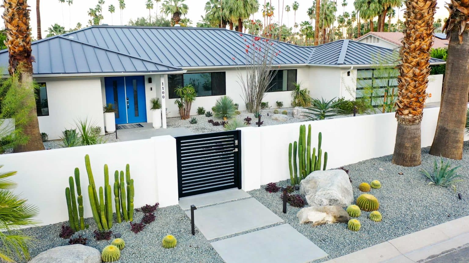 Complete landscape transformation in Palm Springs. Installation includes acid washed hardscape layout, outdoor living area with pizza oven, BBQ, Fireplace, Outdoor shower with breeze block, low voltage lighting, boulders, irrigation and desert plants. Design also includes new driveway automatic gate and new pedestrian entry gate and new garden walls in front yard.