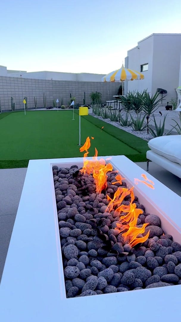 Putting green with flags beside a Lumacast fire feature lounge at the Nugget residence in Palm Springs